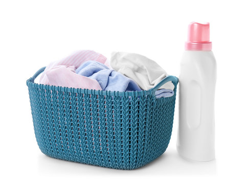 Basket With Dirty Clothes And Laundry Detergent On White Background