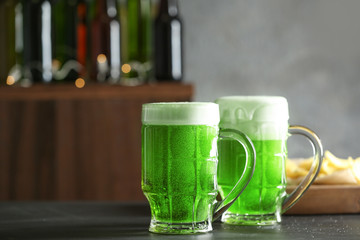 Glasses of green beer on table in bar. Saint Patrick's day celebration