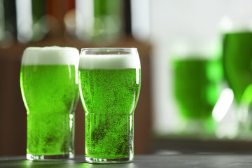 Glasses of green beer on table in bar. Saint Patrick's day celebration
