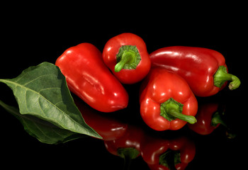Bright fresh red pepper, is isolated on a black background