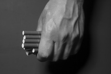 Fototapeta premium Tobacco addiction. Cigarettes on man hand.