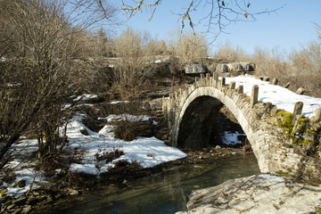 Fototapeta na wymiar bridge old in Ioannina Zagori Greeece snow ice winter time