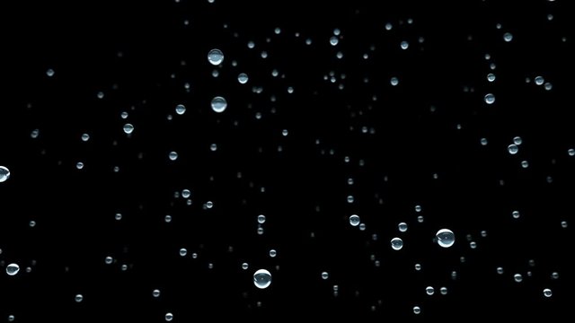 Frozen drops of water in the space on a black background, seamless animation of the flight of the camera