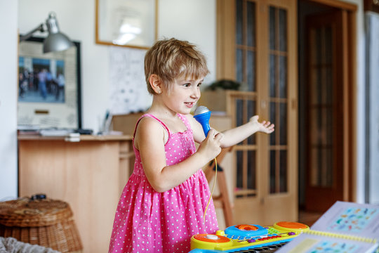 The child sings to the microphone. Conception childhood, upbringing, music.