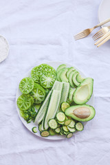 Green plant based salad bowl overhead spring vegan diet food concept