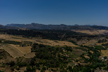 Fototapeta na wymiar Greenery, Mountains, Farms and Fields on the outskirts of Ronda Spain, Europe on a hot summer day