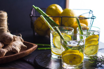 Ingredients for making flu fighting natural hot drink. Oranges, mint, lemons, ginger, honey, apple and spices over plywood background, top view, copy space. Clean eating, detox, dieting concept