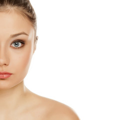 Fototapeta premium half portrait of young girl with makeup on white background