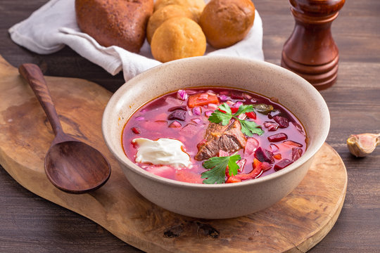 Borscht on wooden platter. First dish with beetroots, cabbage and beef. Traditional Russian and Ukrainian cuisine