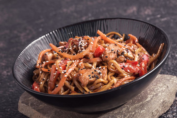 Udon noodles with chicken and vegetables, closeup