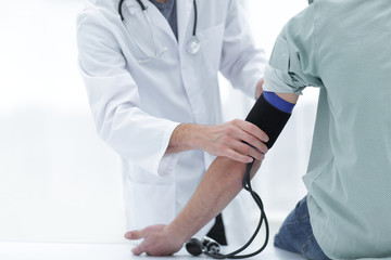 doctor and patient measuring blood pressure