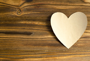 kraft paper heart on wooden background