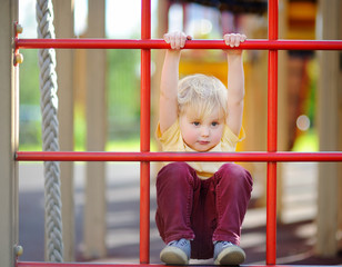 Little boy having fun on outdoor playground