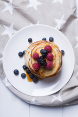 Pancakes with berries and honey