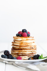 Pancakes with berries and honey. Copy space
