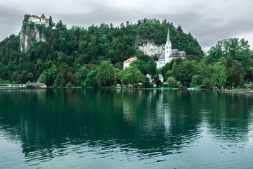 Fototapeta na wymiar Bled lake with church and castle on the mountain, Slovenia
