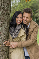 couple in love behind a tree