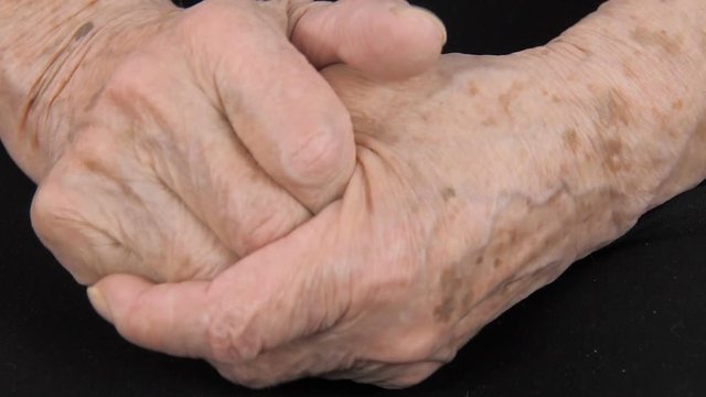 Hands of an old woman close-up.