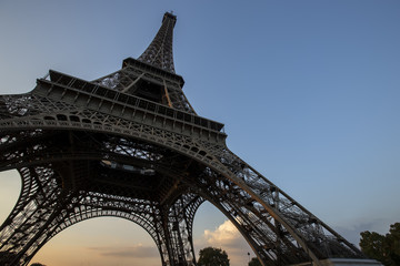 Eiffel Tower at sunset in Paris, France. Romantic travel background.