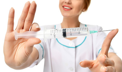 Doctor or nurse with big syringe needle for flu injection vaccination concept 