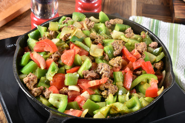 Hamburger, peppers, tomatoes simmering