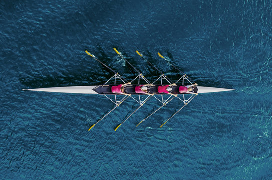Women's rowing team on blue water