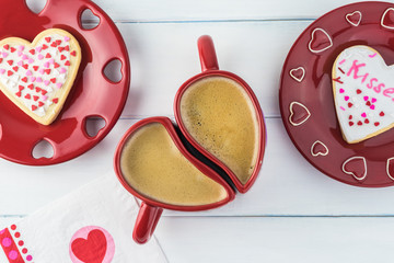 Valentines Day heart shaped cookies and coffee in heart shaped cups.