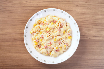 Italian wagon wheel shape pasta with ham and corn