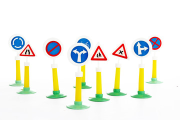 Fototapeta na wymiar Road signs The Highway Code, road safety and vehicle rules driving law road sign toys.