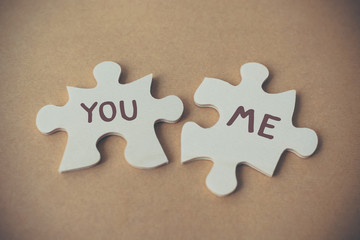 Jigsaw puzzle two pieces and wording you and me, Concept lover and international valentine day