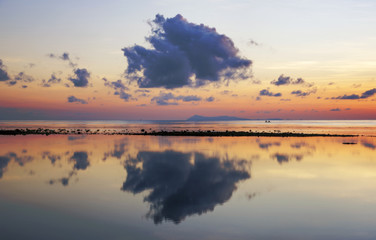 Beautiful clouds reflection at sunrise in Kudat beach, Malaysia