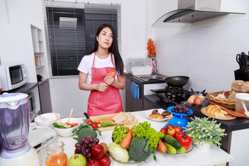woman holding a carrot in kitchen room