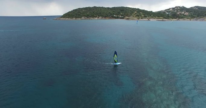 Aerial view of a windsurfer on the calm sea surface
