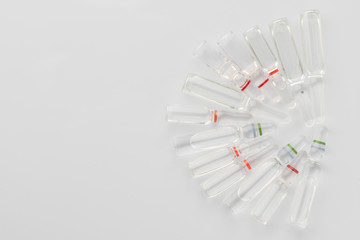 Medical ampoules of liquid for injection on a white background. The view from the top