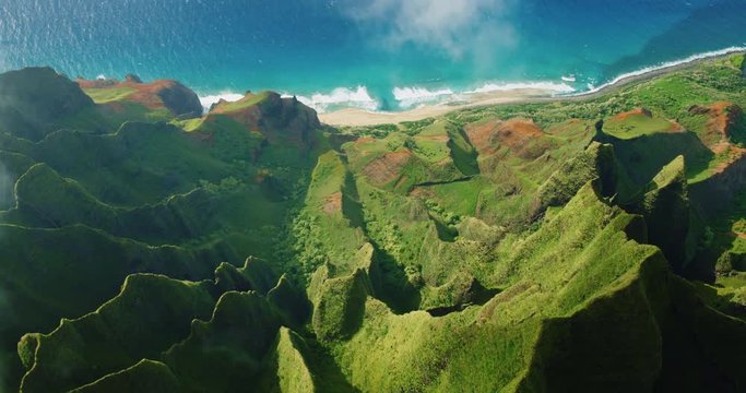 Cinematic aerial view of dramatic mountains and ocean on Napali Coast, Kauai, Hawaii