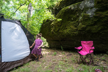Girl Opens Tent Surrounded by Ozark Bluffs