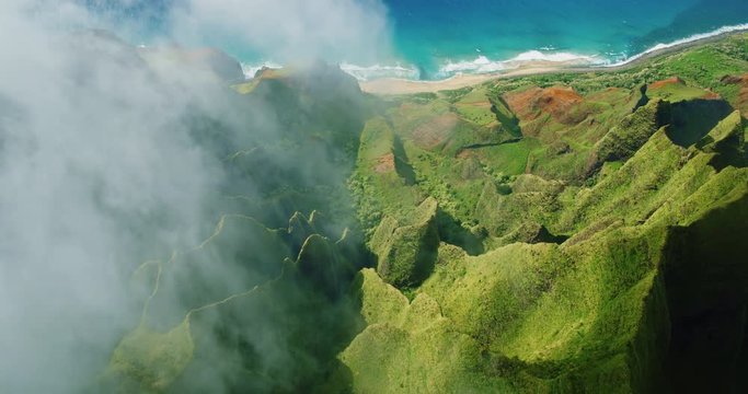 Cinematic aerial view of dramatic mountains and ocean on Napali Coast, Kauai, Hawaii