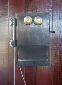 Antique old telephone hang on wooden wall