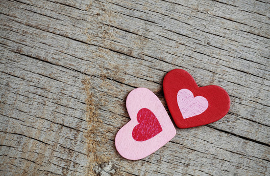 red and pink hearts on wooden.