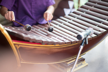 Little asian Thai boy playing alto xylophone music performance in ceremony