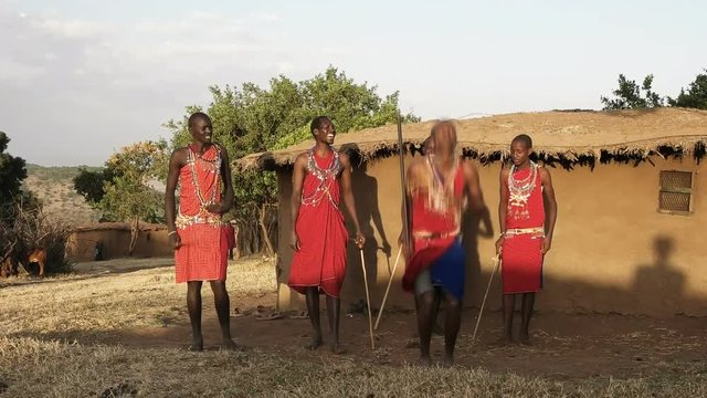 60p wide shot of five maasai warriors dancing at a village near masai mara- originally recorded at 120fps