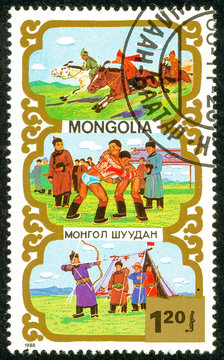 Ukraine - circa 2018: A postage stamp printed in Mongolia shows Horsemanship, Wrestling, Archery, bow, arrows, weapons - Traditional Mongolian sport. Series: Sports. Circa 1988.