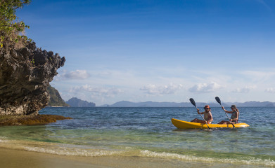 Couple canoeing in lagoon of West  French indies