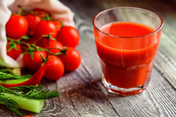 Glass of tomato juice with fresh tomatoes