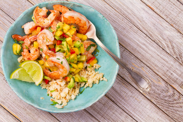 Shrimps with mango avocado salsa and cauliflower rice. View from above, top, horizontal