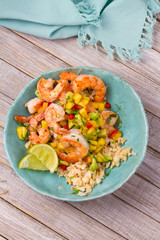 Shrimps with mango avocado salsa and cauliflower rice. View from above, top, vertical