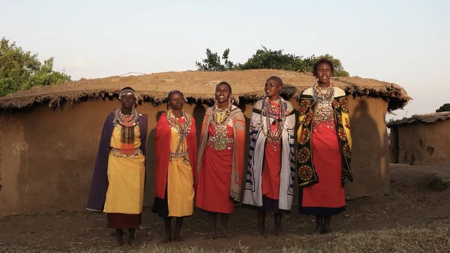 wide shot of a group of maasai women singing in enkereri village near masai mara, kenya