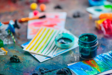 Artist tools in creative occupation concept. Brushes, watercolor swatches and paints. Artistic workplace.