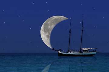 Moon sailing of dreams voyage at the paradise sea. 
Big moon looks like the sail of the old wooden...