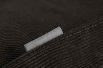 Velvet fabric with a seam along the diagonal and a gray label, close-up.